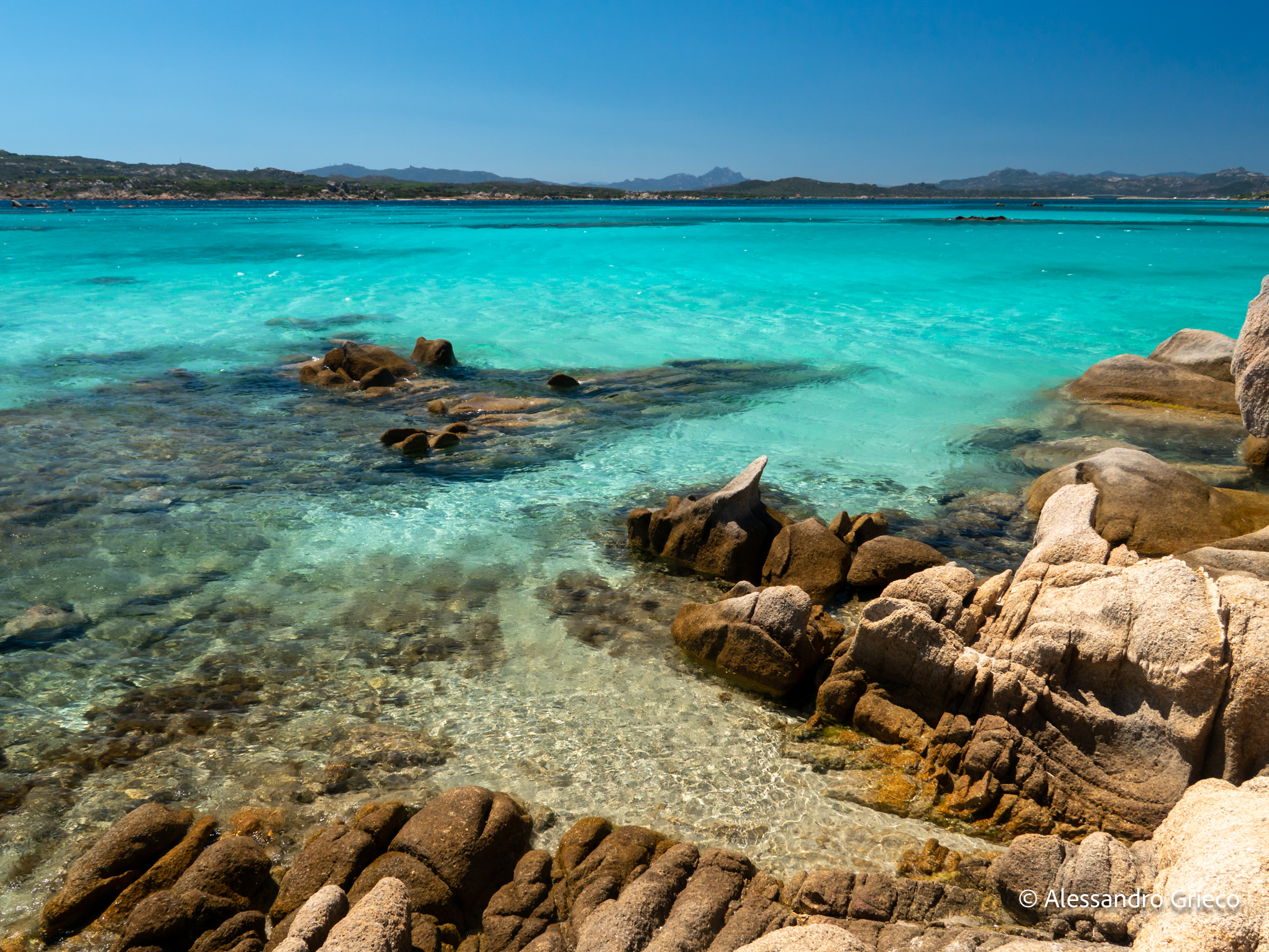 Sardinia · the water along the coast, turquoise over pale granite